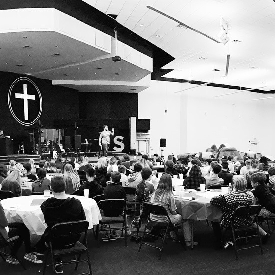 Clark speaking with students at a church gathering